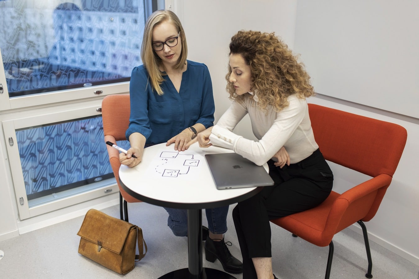 Two people using a visual model for a discussion.
