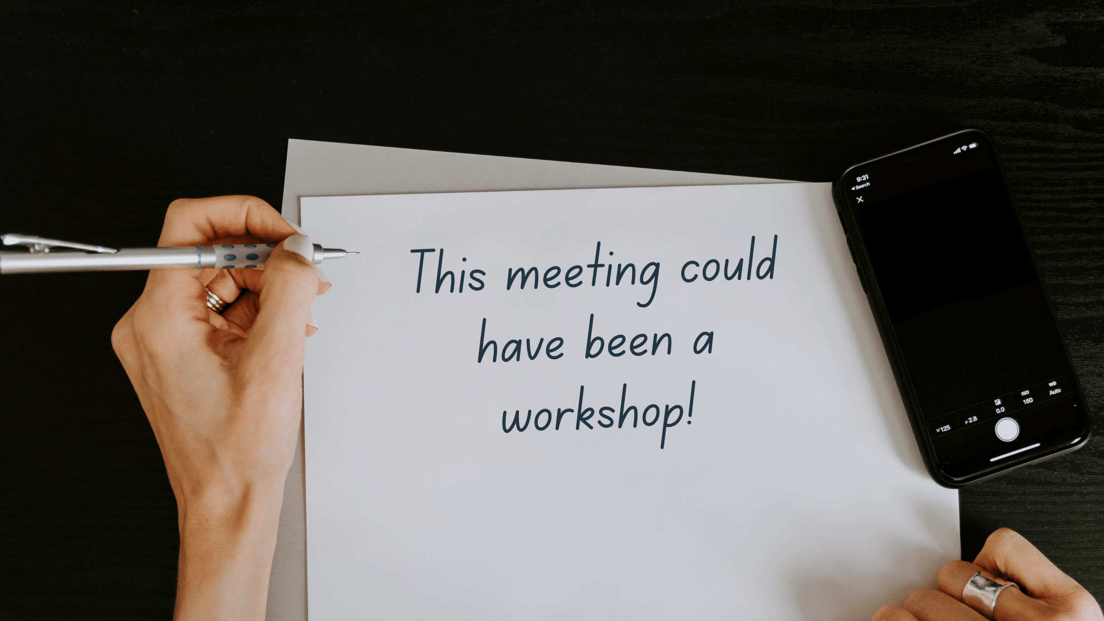 http://Hand%20holding%20a%20pen,%20in%20the%20middle%20a%20paper%20with%20text%20This%20meeting%20could%20have%20been%20a%20workshop