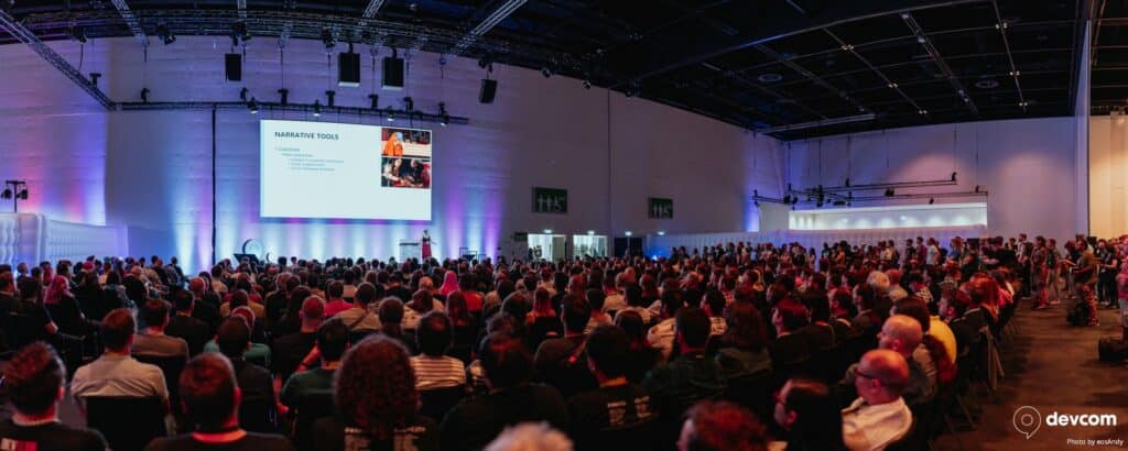 Large audience seated in a large conference hall.